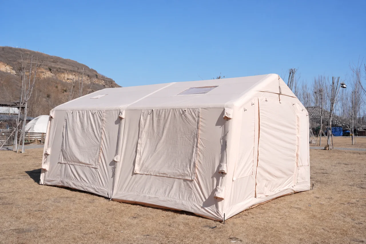 Large beige inflatable glamping lodge viewed from the side with window covers closed