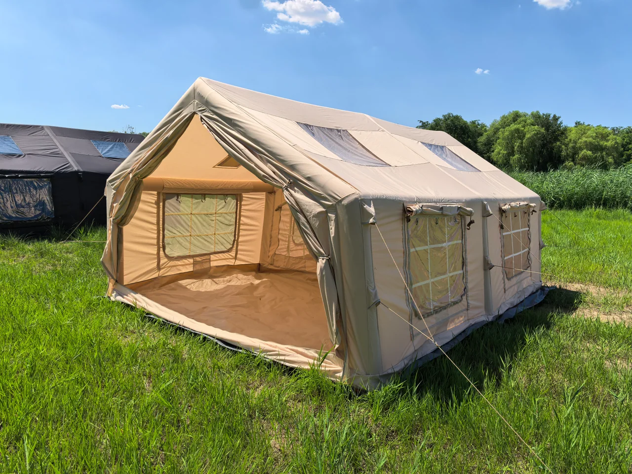 Large inflatable camping tent exterior with the front opening raised